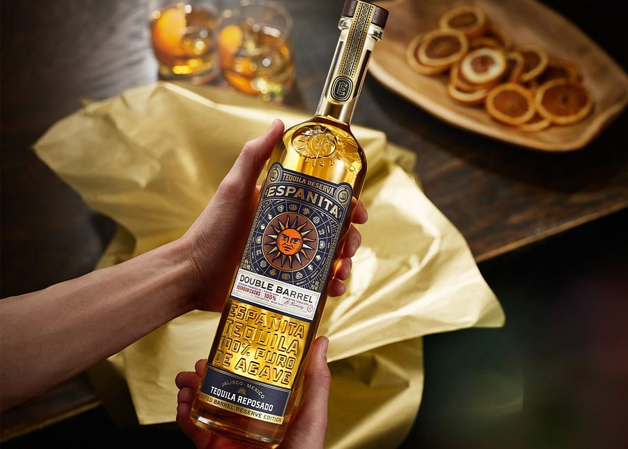 Limited edition tequila bottles with intricate designs on a wooden shelf, showcasing rarity and collectibility